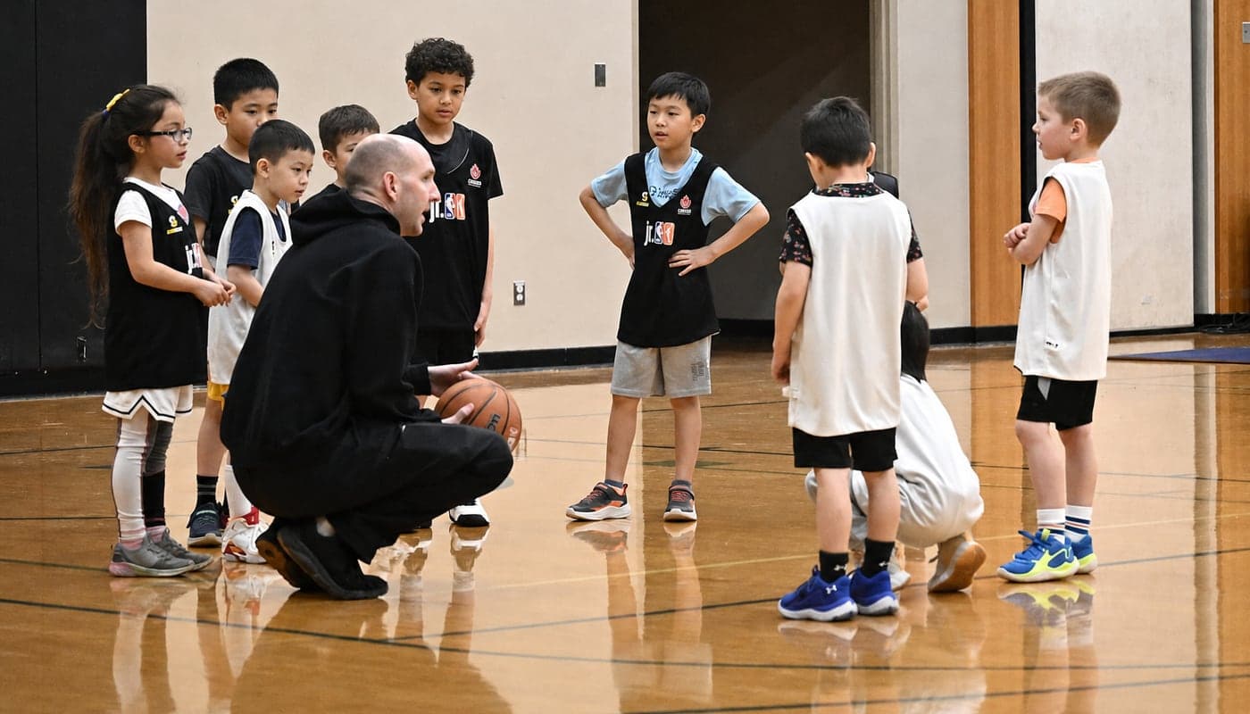 An NLBA coach leading a session with a group of young players