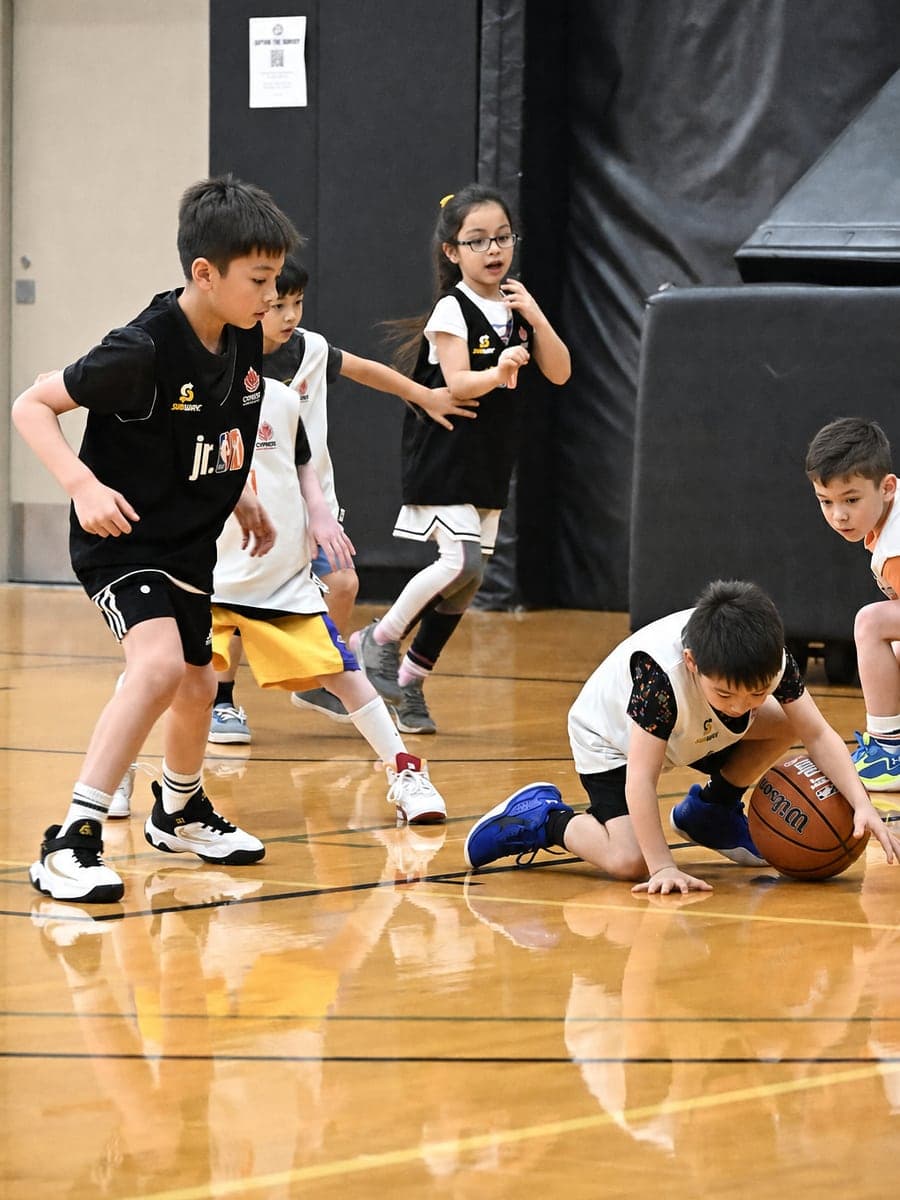 Young North Langley players chasing a loose ball during a Jr. NBA session