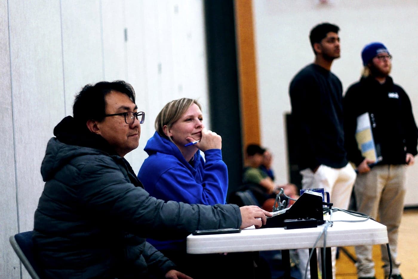 NLBA volunteers keeping score and time at the scorer's table during a game